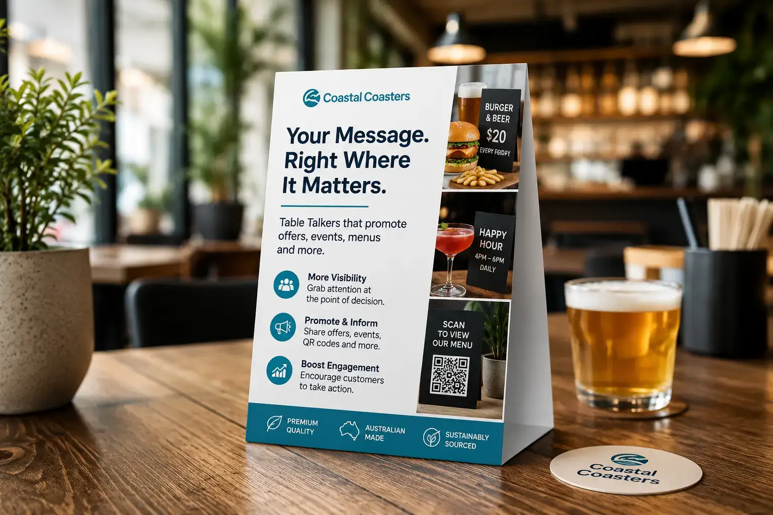 Coastal Coasters' printed table talker was displayed on a wooden restaurant table beside a beer glass and branded coaster.