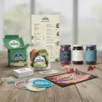 Coastal Coasters' branded promotional kit featuring custom food packaging, a printed menu, jars, drink coasters, cards, stickers, and a bar mat.