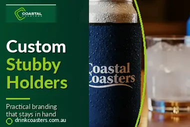 Coastal Coasters' promotional graphic showing a branded stubby holder wrapped around a chilled drink, with the text “Custom Stubby Holders” and “Practical branding that stays in hand.”